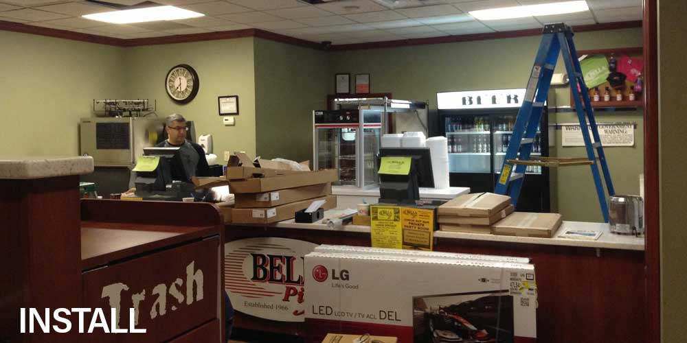 Bella Pizza during the install: old boards down, new screens in their boxes