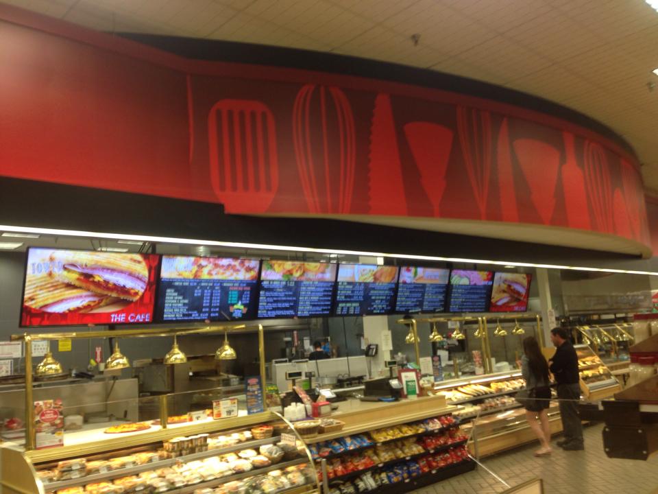 Tops Friendly Markets café: a row of seven impulseGUIDE menu screens over the deli counter